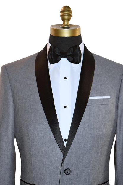 very close up mannequin wearing alight-gray shawl collar tuxedo with black bow tie on a white background