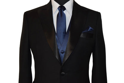 close-up black peak lapel tuxedo with marine blue necktie with subtle stripe and a marine-blue satin vest against a white background 