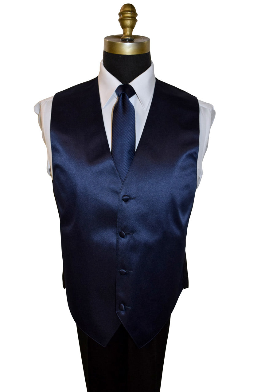 mannequin wearing a white dress shirt with a marine-blue necktie with a subtle stripe and a marine-blue satin vest against a white background 