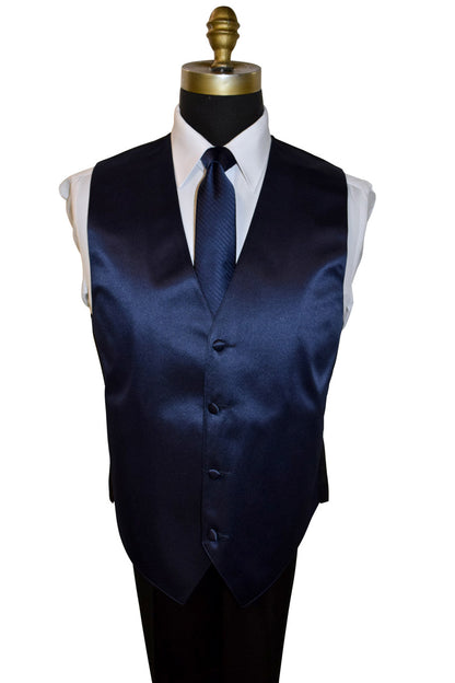 mannequin wearing a white dress shirt with a marine-blue necktie with a subtle stripe and a marine-blue satin vest against a white background 