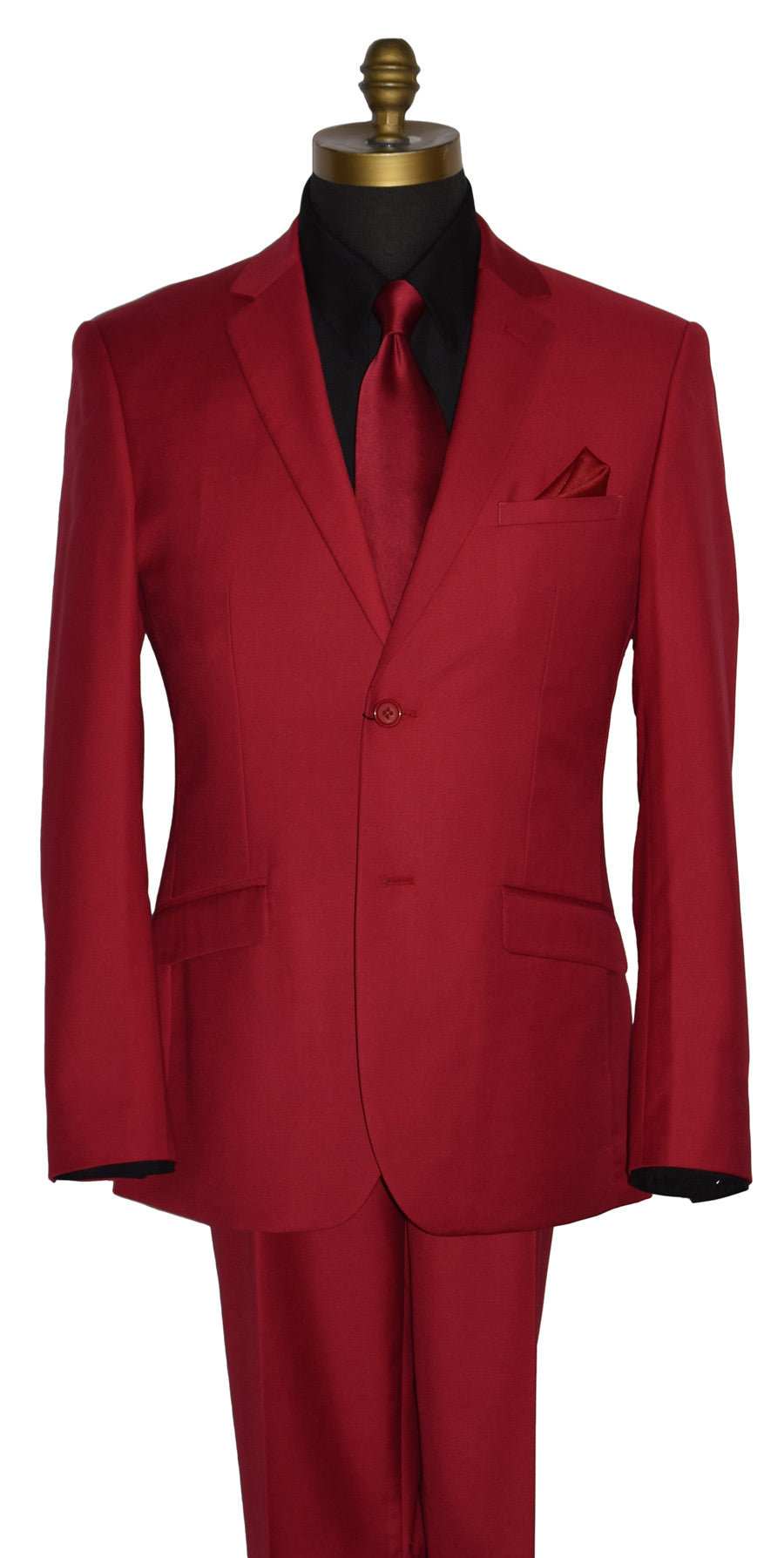 close-up Life size mannequin wearing a red men's suit with a black shirt and a long red necktie with a red pocket handkerchief against a white background