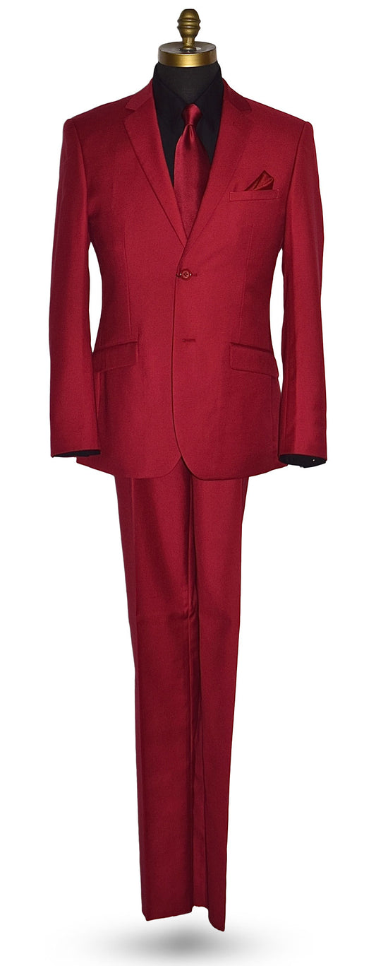 Life size mannequin wearing a red men's suit with a black shirt and a long red necktie against a white background