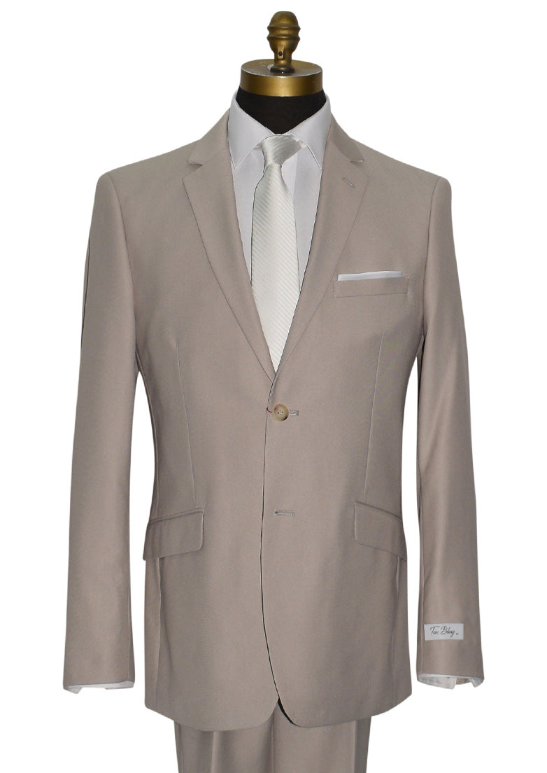 close-up mannequin wearing beige mens suit with white long dress tie and "tux bling" branded label against a white background