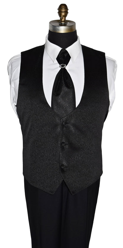 Black nehru vest with a white shirt and black tie on a mannequin against a white background