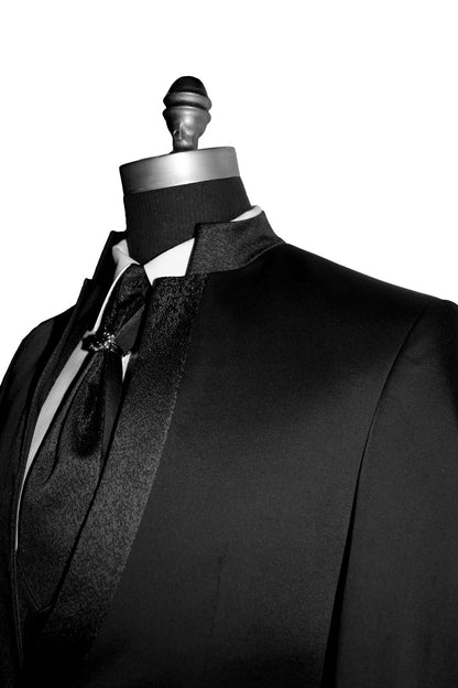 side view-close-up Black tuxedo with bow tie on a mannequin against a white background