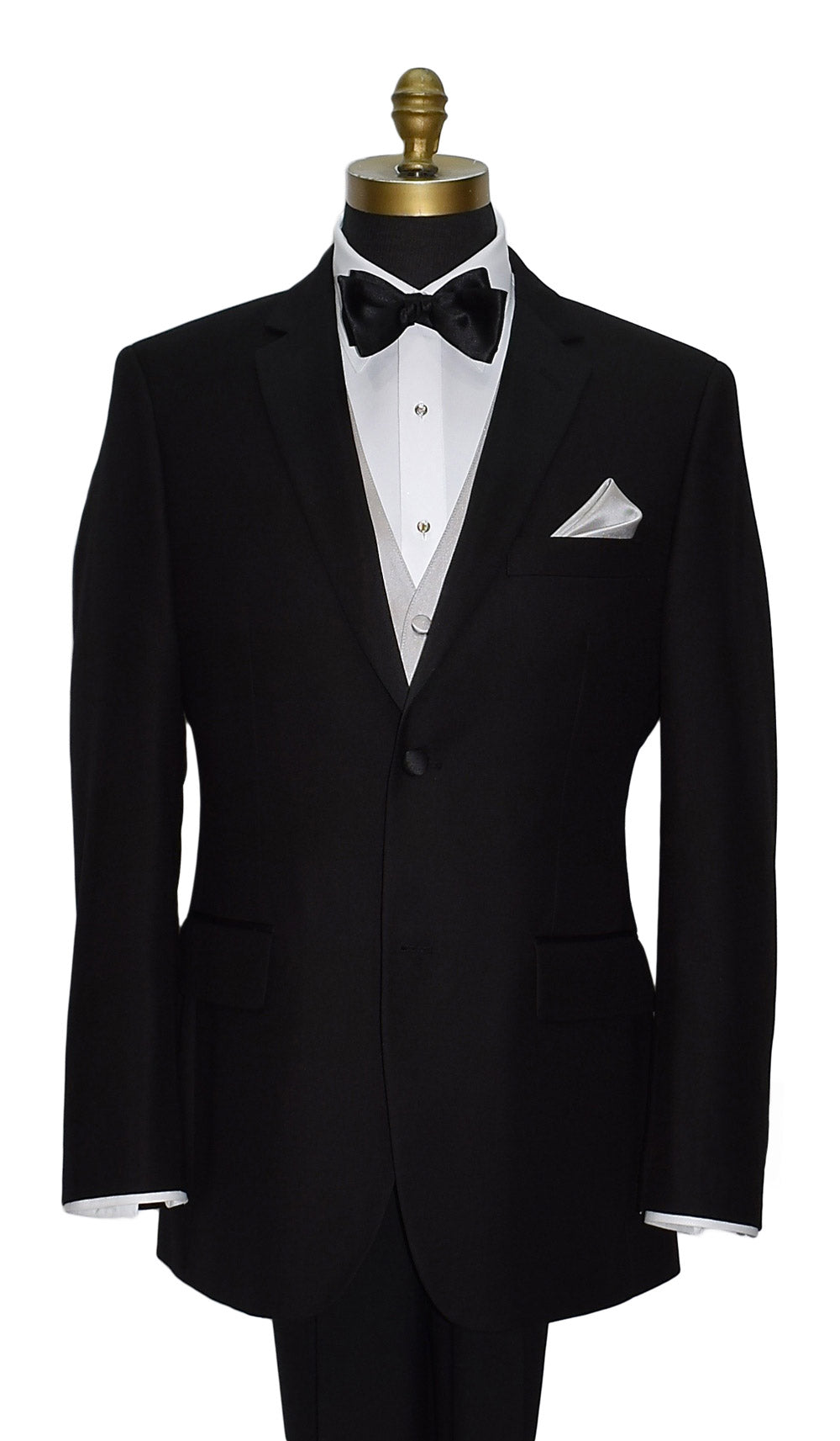 Black tuxedo with white dress shirt and moonlight-vest with a black "pre-tied" bow tie and pocket handkerchief on a mannequin against a white background