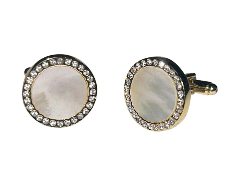 close up of mother of pearl cufflinks with gold setting with crystals against a white background