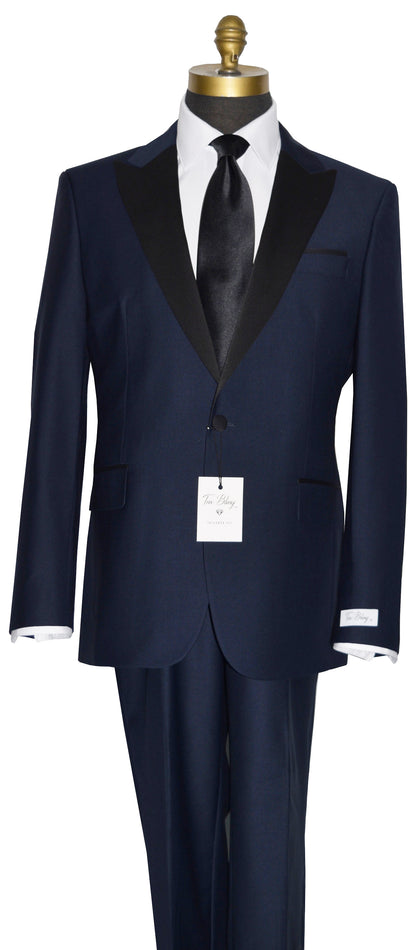 Navy blue tuxedo with black lapels and a black satin necktie on a mannequin against a white background
