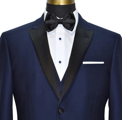 CLOSE-UP of a Navy blue 3 piece tuxedo with black lapels shown with a black satin "pre-tied" bowtie against a white background.