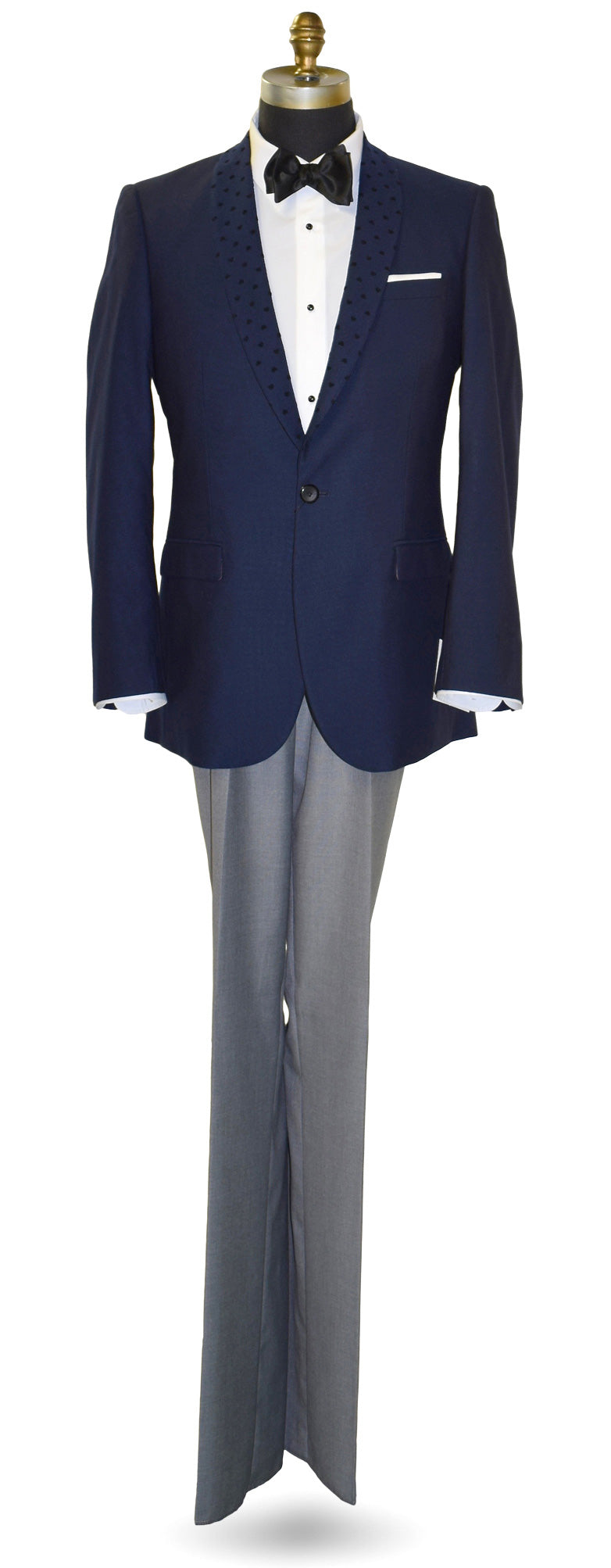 navy-blue shawl collar tuxedo wearing a black bowtie with gray pants on a white background