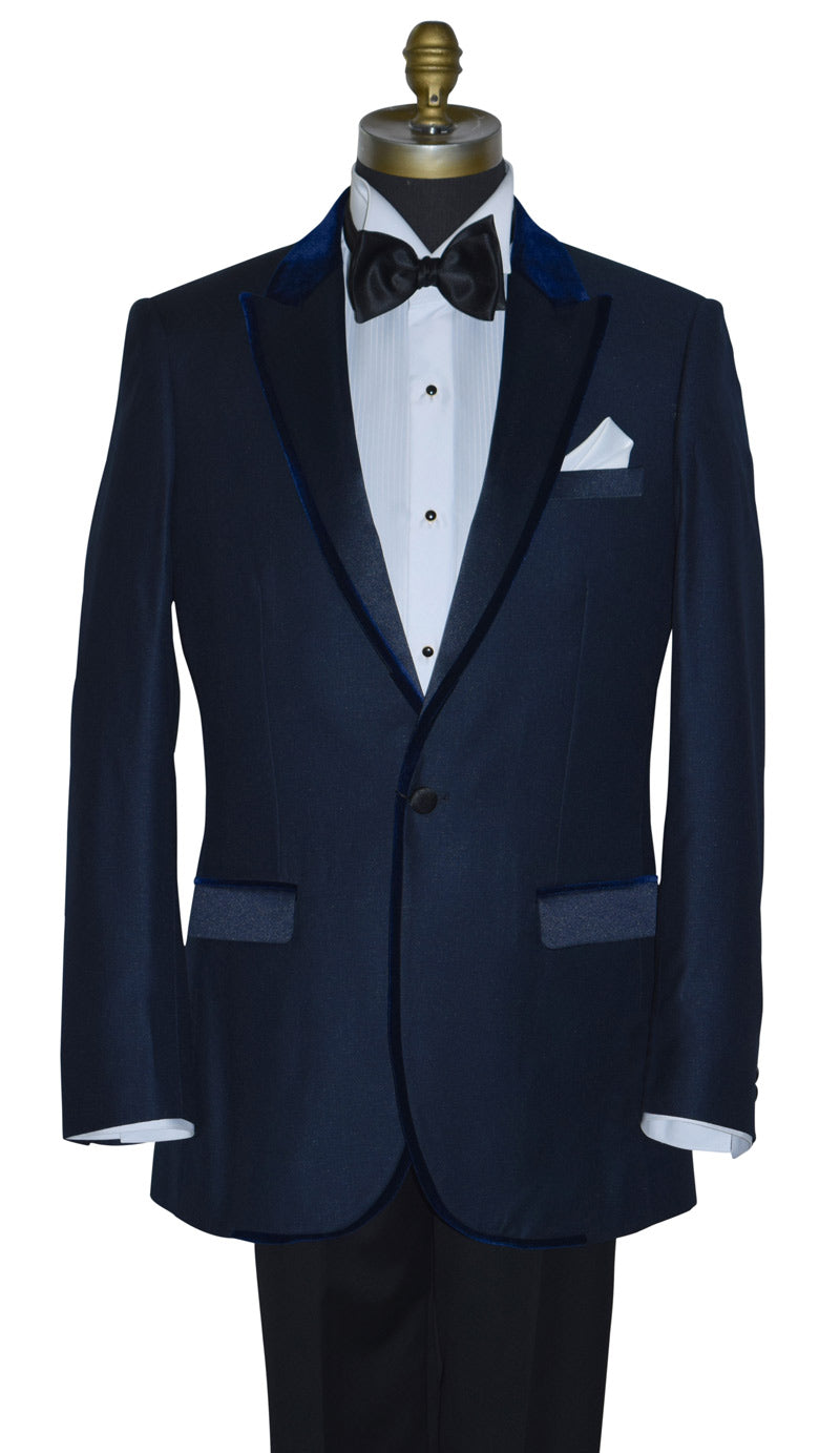 Navy blue tuxedo with navy blue velvet trim on a mannequin with a bowtie against a white background
