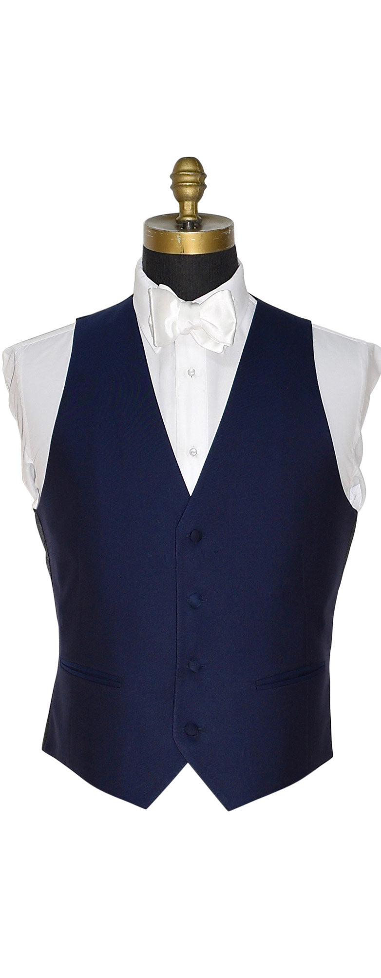 Navy blue tuxedo vest on a mannequin with a white shirt against a white background