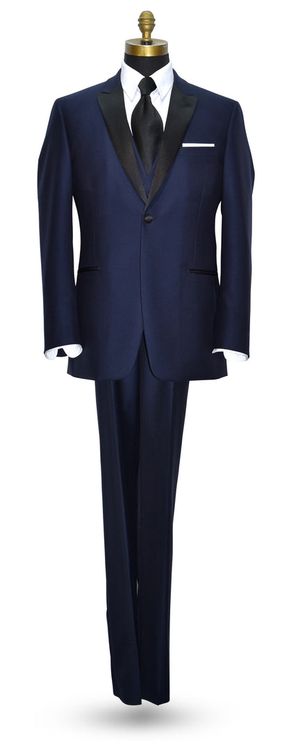mannequin wearing a navy blue tuxedo with black peal lapels with matching navy tuxedo pants with white shirt and long wide satin dress tie against a white background