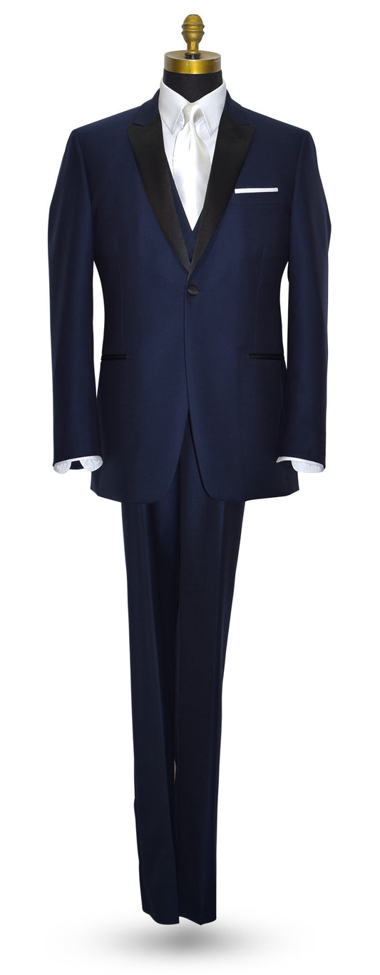 mannequin wearing a navy blue tuxedo with black peal lapels with matching navy tuxedo pants with white shirt and long white satin dress tie against a white background