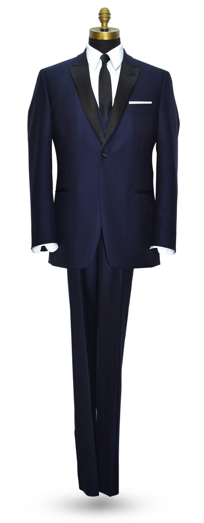 Life size mannequin wearing Navy-Blue peak lapel tuxedo with navy blue tuxedo vest and skinny black satin necktie against a white background
