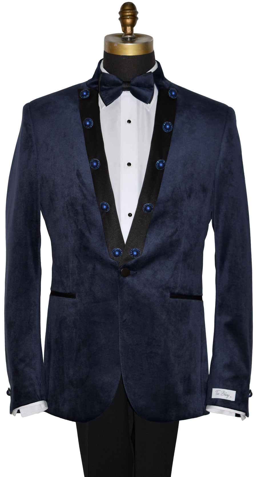 front view close-up mannequin wearing a navy velvet nehru collar tuxedo with a navy bowtie against a white background