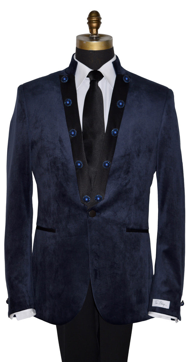 close-up mannequin wearing a navy velvet nehru collar tuxedo with a long black dress tie against a white background