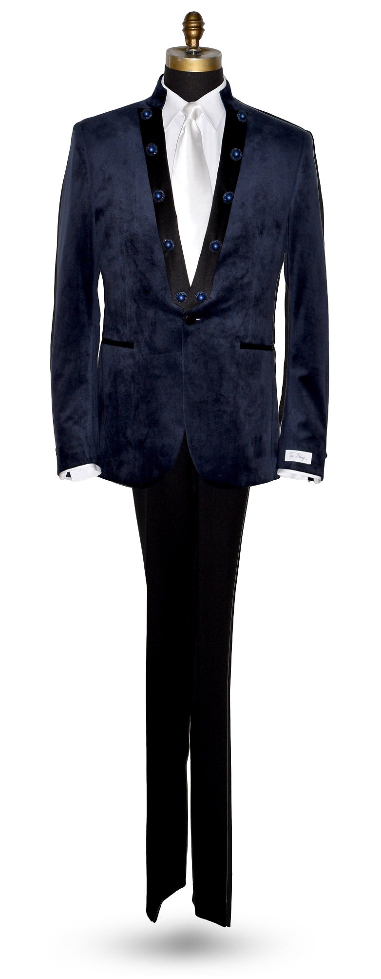 life size mannequin wearing a navy velvet nehru collar tuxedo with a long white dress tie against a white background
