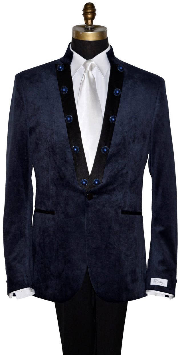 close-up front view mannequin wearing a navy velvet nehru collar tuxedo with a long white dress tie against a white background