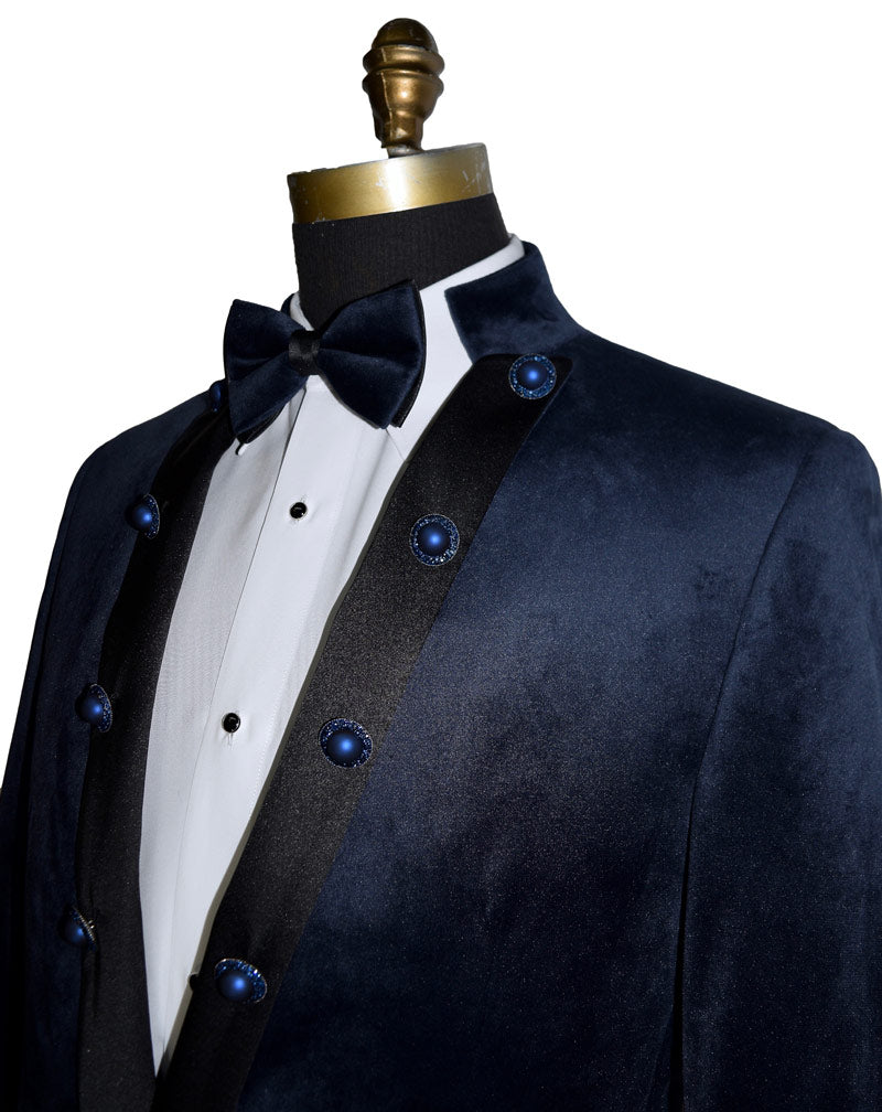 close-up side view mannequin wearing a navy velvet nehru collar tuxedo with a navy bowtie against a white background