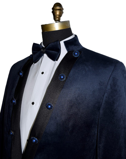 close-up side view mannequin wearing a navy velvet nehru collar tuxedo with a navy bowtie against a white background