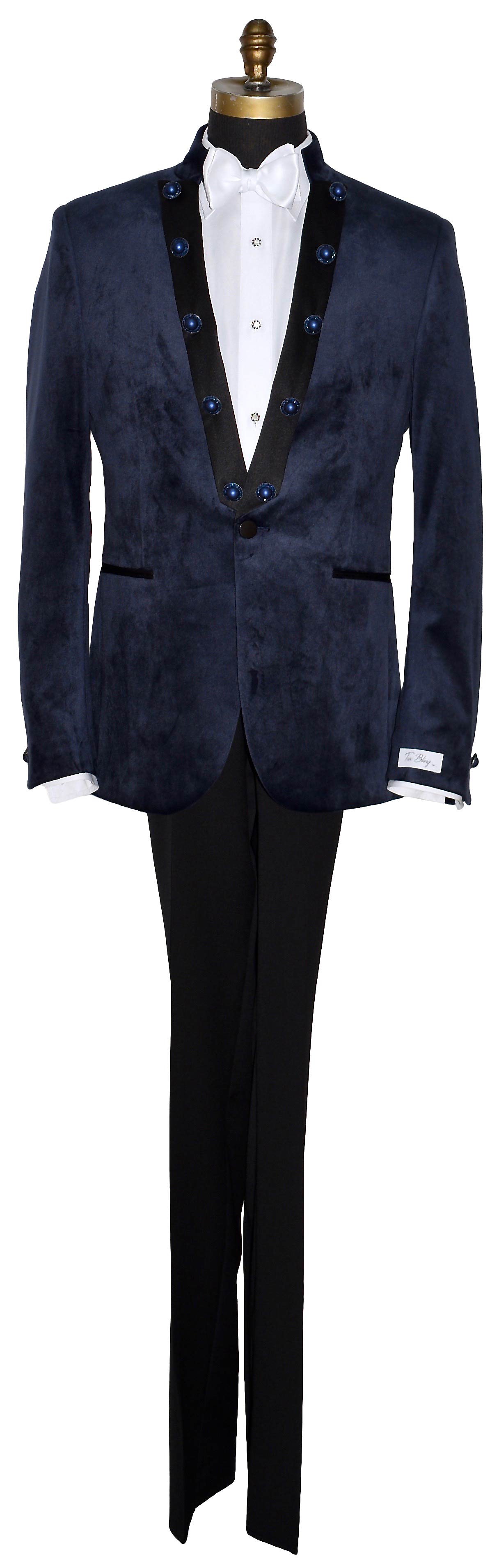 life size mannequin of navy blue velvet nehru collar tuxedo with a white bowtie against a white background