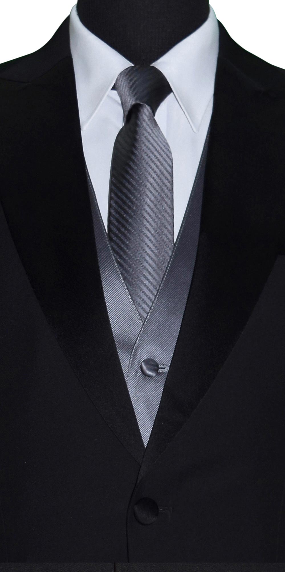 very close up mannequin wearing a black peak lapel tuxedo with a white shirt and charcoal satin vest and charcoal necktie with a subtle charcoal stripe against a white background