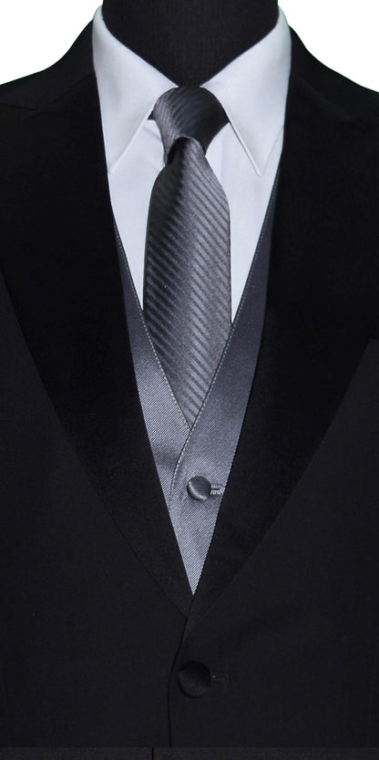 very close up mannequin wearing a black peak lapel tuxedo with a white shirt and charcoal satin vest and charcoal necktie with a subtle charcoal stripe against a white background