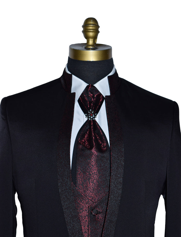 super close-up black nehru tuxedo ensemble with red accents on a mannequin against a white background