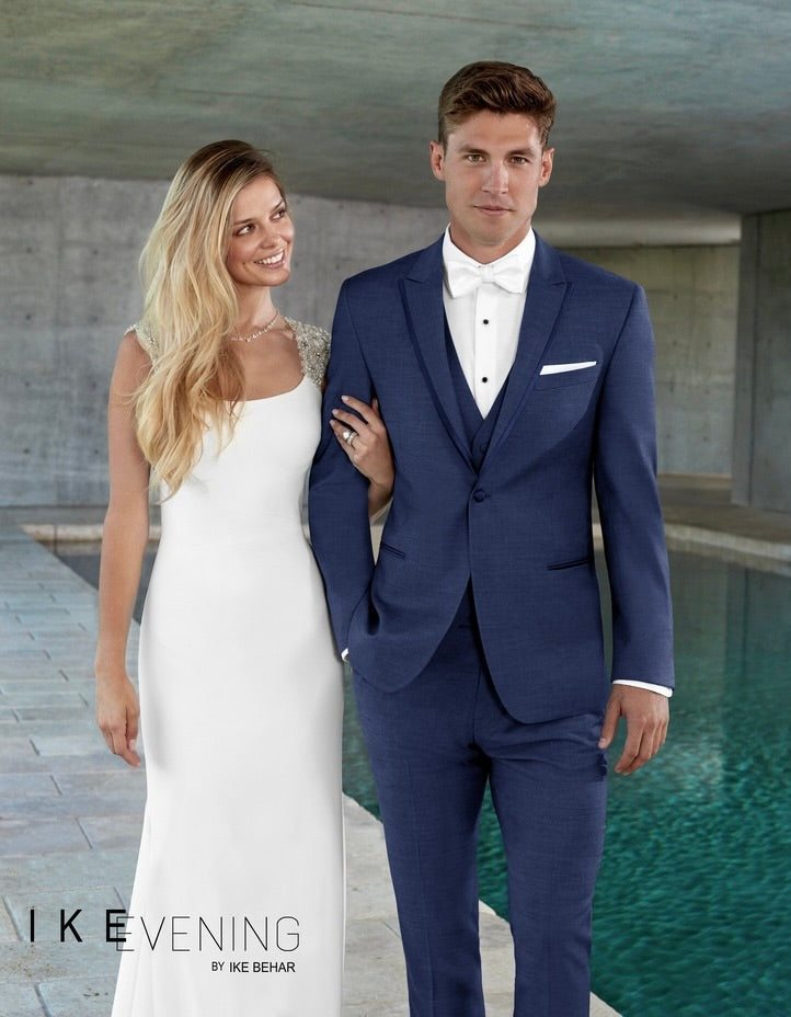 Groom in a "new-blue" tuxedo with blue peak lapels with satin trim shown with a white "pre-tied"bowtie nad matching new-blue vest.