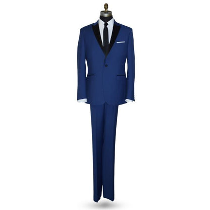 Mannequin wearing a royal-blue tuxedo with black peak lapel, royal blue trousers, and a black skinny dress tie, against a white background.