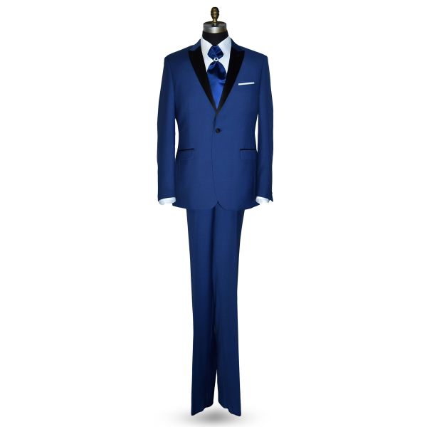 Mannequin wearing a royal-blue tuxedo with black peak lapel, royal blue trousers, and a royal blue ascot tie, against a white background.
