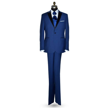 Mannequin wearing a royal-blue tuxedo with black peak lapel, royal blue trousers, and a royal blue ascot tie, against a white background.