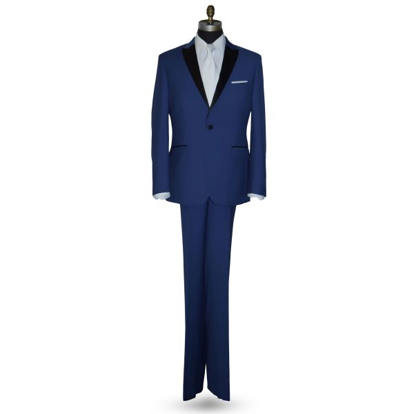 Mannequin wearing a royal-blue tuxedo with black peak lapel, royal blue trousers, and a long white dress tie, against a white background.