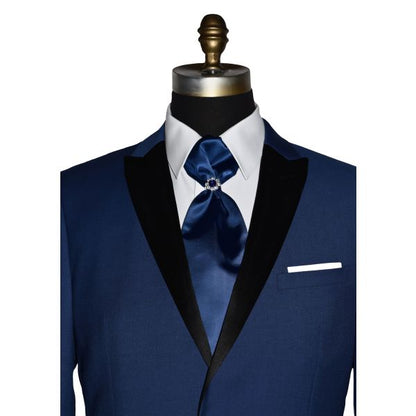 super close up Mannequin wearing a royal-blue tuxedo with black peak lapel, royal blue trousers, and a royal blue ascot tie, against a white background.