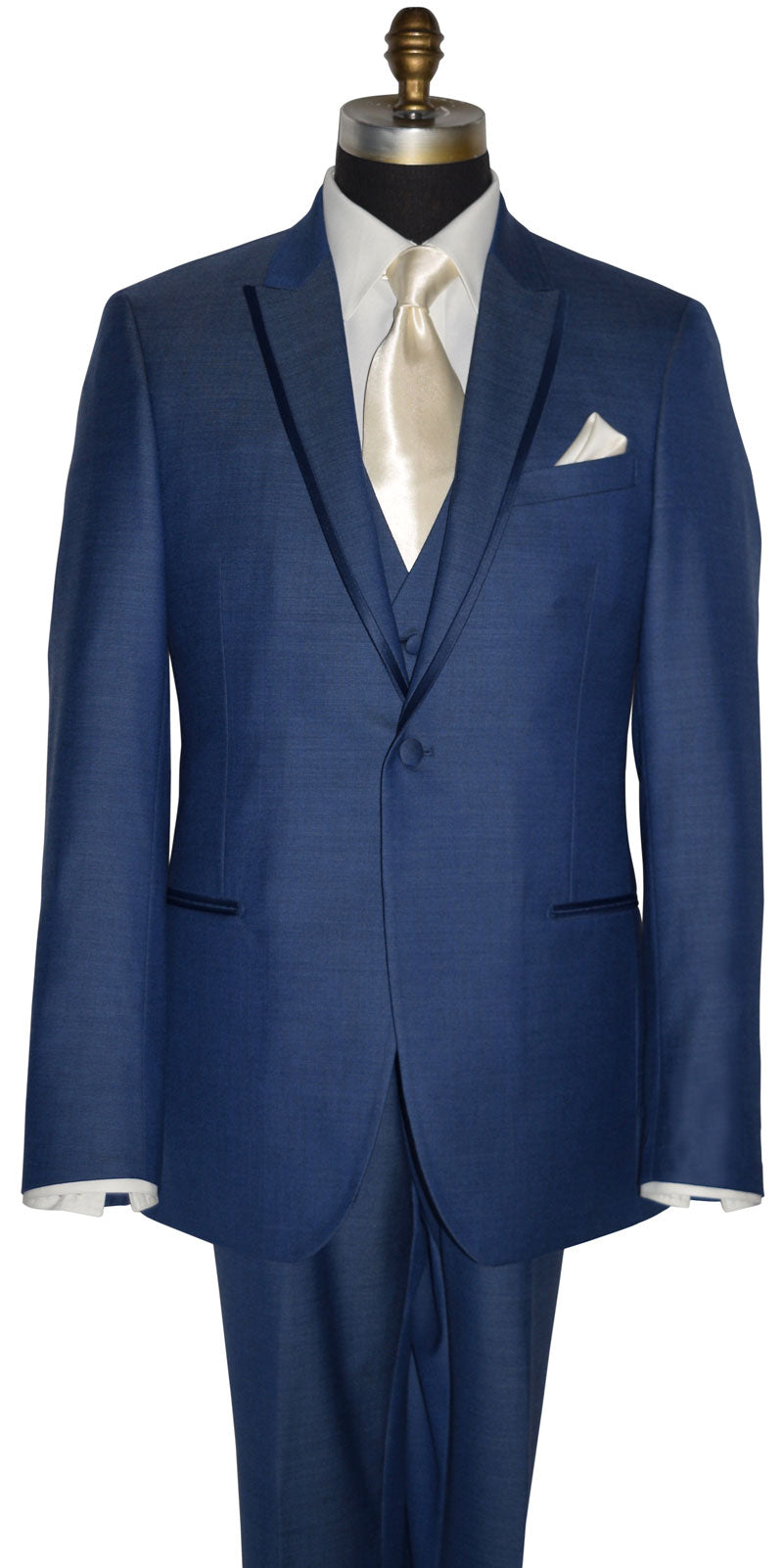 front view close up mannequin wearing a new-blue three piece tuxedo with an ivory dress shirt with an ivory long necktie and ivory pocket handkerchief against a white background