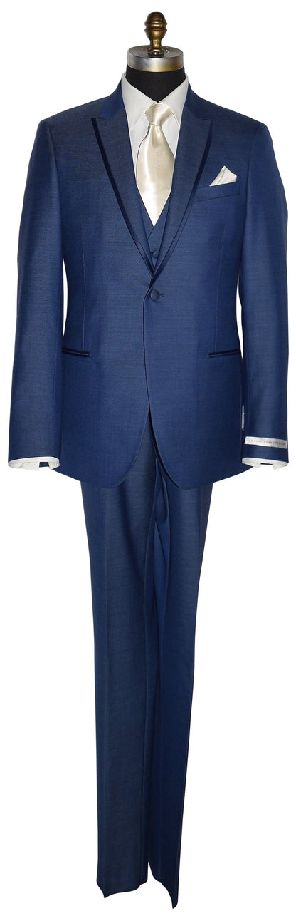 life-size mannequin wearing a new-blue three piece tuxedo with an ivory dress shirt with an ivory long necktie and ivory pocket handkerchief against a white background