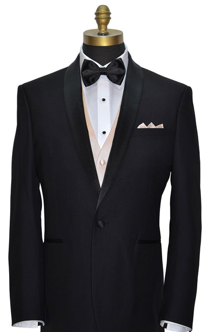 Black shawl-collar tuxedo with white tuxedo shirt, nude tuxedo vest- black "pre-tied" bow tie, and petal pocket square, black studs and cufflinks, on a mannequin against a white background.