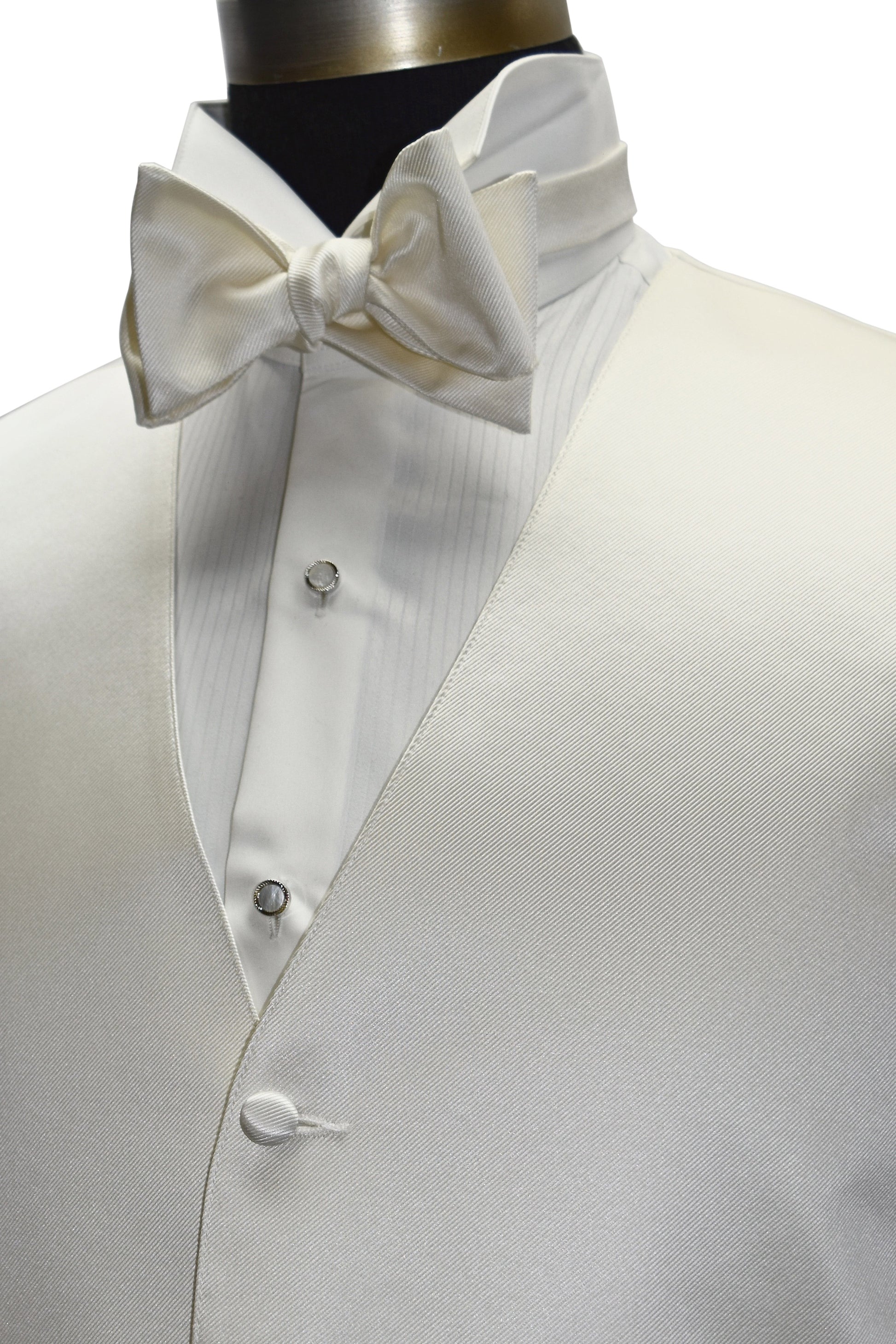 close-up side view - off-white tuxedo vest with an off-white "tie-yourself" bowtie on a mannequin against a white background