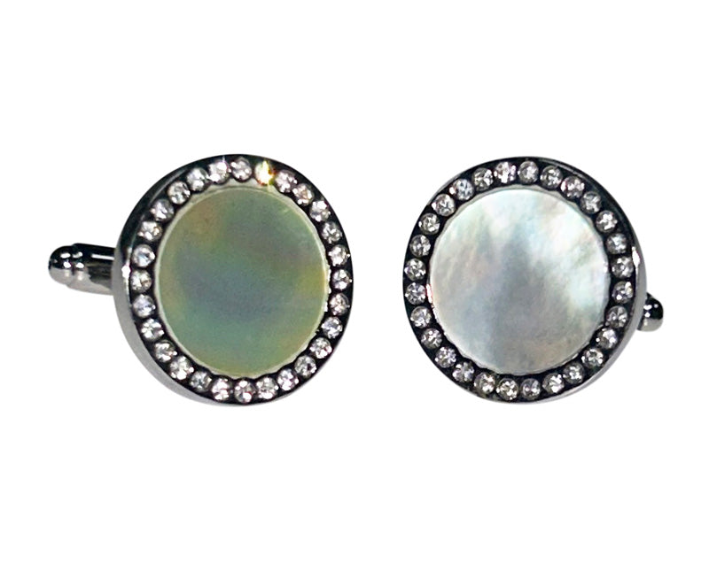 mother-of-pearl cufflinks with crystal and silver setting against a white background