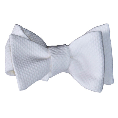 White pique bowtie that you tie yourself on a white background