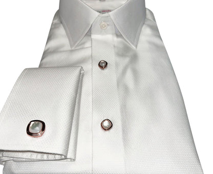 White dress shirt with pearl cufflinks and studs in rose goldsetting on a white background