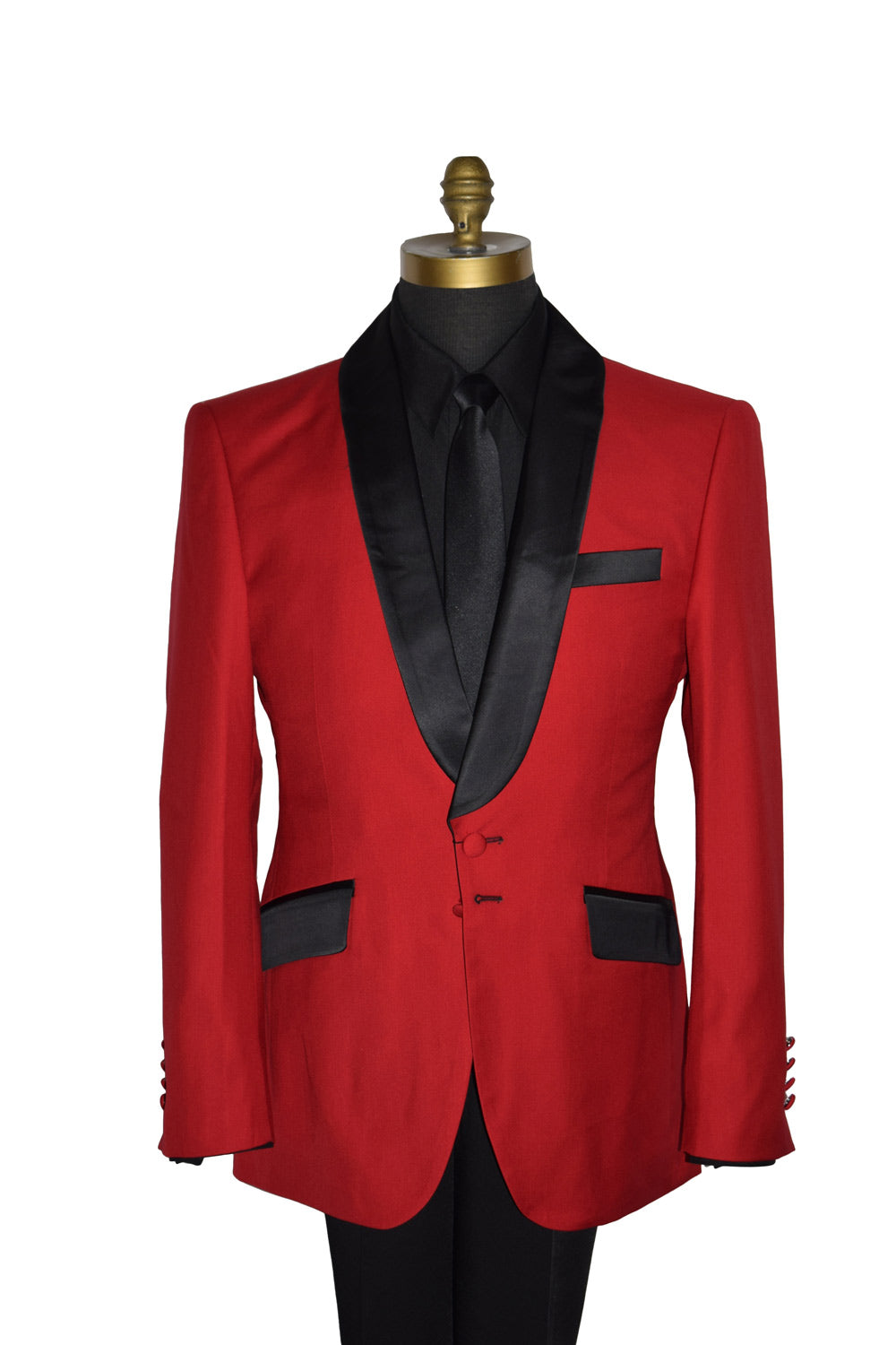 close-up life size mannequin wearing red shawl collar tuxedo with a black tuxedo shirt and a long black necktie with black tuxedo pants