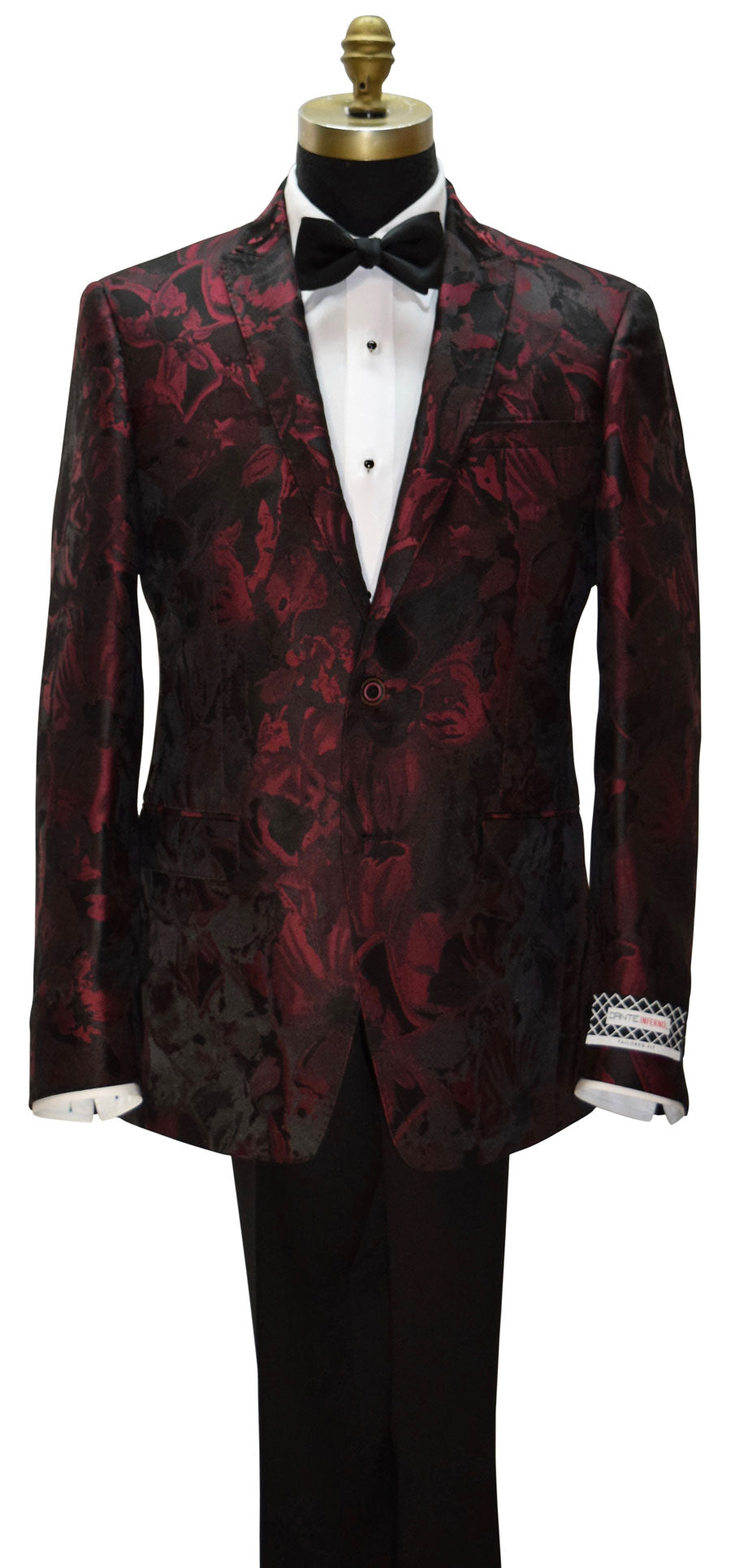 close-up of a Red floral patterned tuxedo jacket on a mannequin with a white shirt and black bow tie with a Dante Inferno brand label on the sleeve