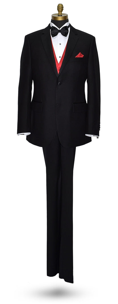 life-size mannequin wearing a black notch-lapel tuxedo with a white dress shirt with a black satin bowtie and ruby red vest and pocket handkerchief against a white background
