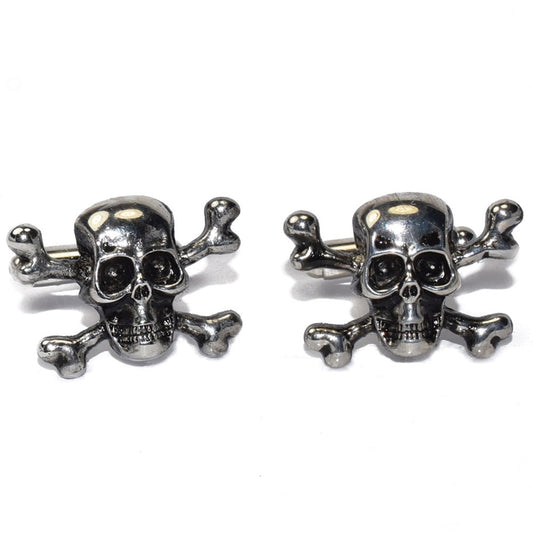 Pair of silver "skull and crossbones" cufflinks on a white background