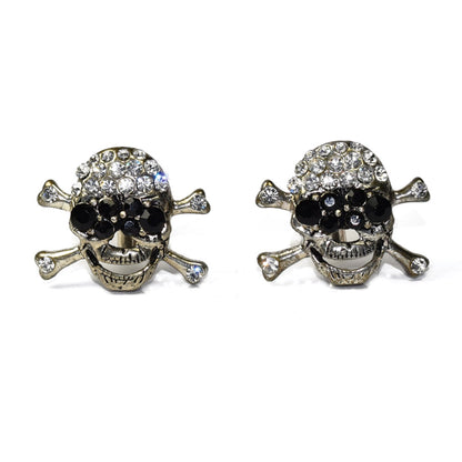 Pair of largeskull and crossbones cufflinks with gemstones on a white background