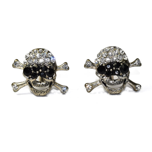 Pair of largeskull and crossbones cufflinks with gemstones on a white background