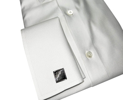 White dress shirt with square gunmetal cufflink on a white background