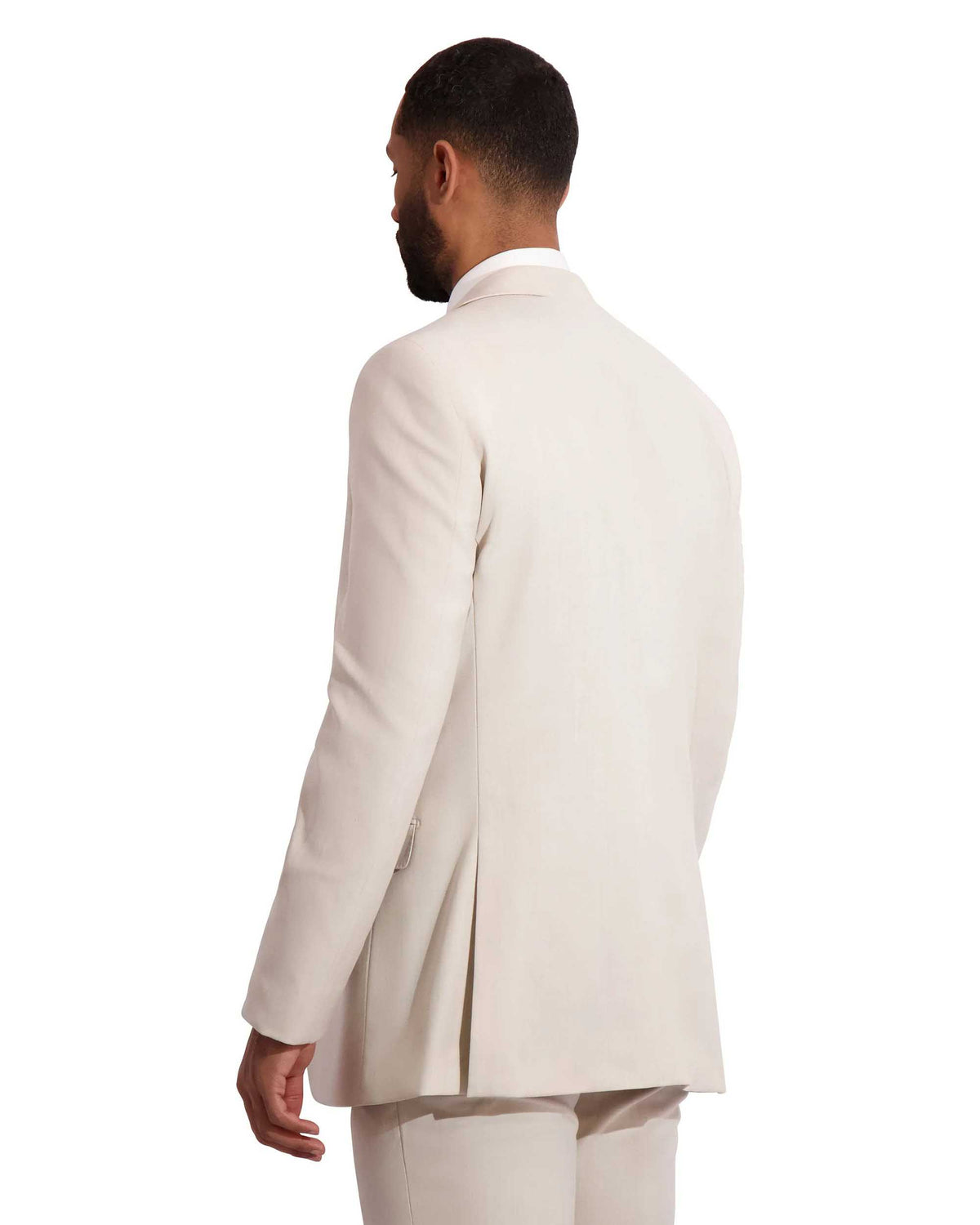 Back View of hispanic model wearing a tan fitted wedding suit.